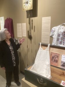 Justina Neufeld points to the white slip in a museum exhibit